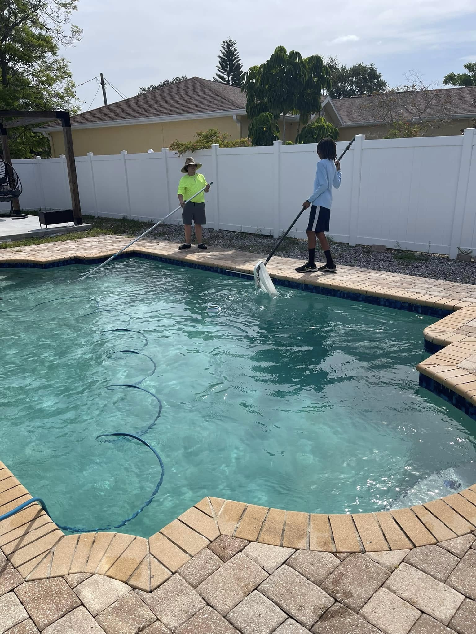 Pool technician speaking with homeowner about service options
